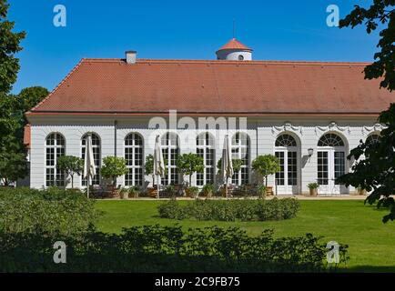 Neuhardenberg, Allemagne. 31 juillet 2020. Le bâtiment de l'Orangerie dans le jardin de la Fondation Schloss Neuhardenberg. En arrière-plan, la tour de l'église de Schinkel s'élève dans le ciel bleu. Après la pause liée à une pandémie, le Stiftung Schloss Neuhardenberg se déplace à l'extérieur avec un nouveau programme d'été à partir du 1er août 2020. Jusqu'en 23.08.2020, environ 20 événements dans le parc du château sont sur le programme. Credit: Patrick Pleul/dpa-Zentralbild/ZB/dpa/Alay Live News Banque D'Images