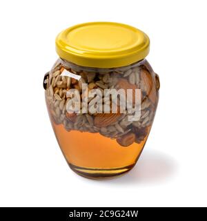 Pot en verre avec miel, noix et graines isolées sur fond blanc Banque D'Images