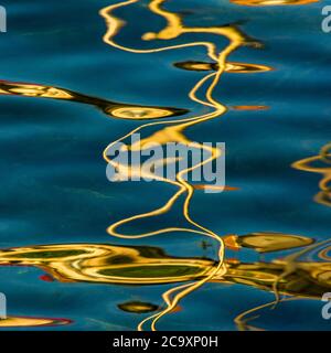 Reflets de la lumière du soleil créant des motifs abstraits sur la surface de l'eau en fin d'après-midi Banque D'Images