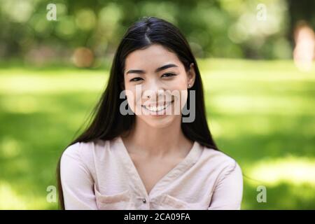 Beauté exotique. Portrait d'une fille asiatique souriante posant à l'extérieur dans Green Park Banque D'Images