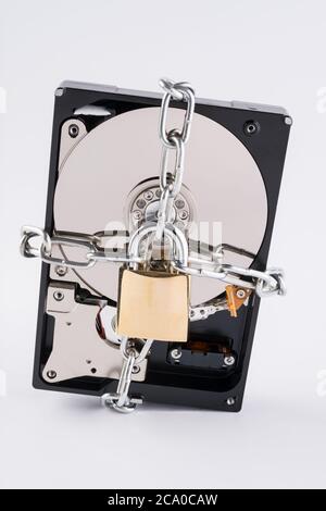 Un disque dur de 3.5 pouces (HDD) fixé par une chaîne et un cadenas. Banque D'Images