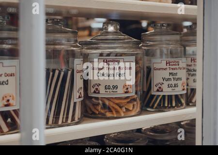 Broadway, Royaume-Uni - 07 juillet 2020 : des friandises pour chiens gastronomiques dans des bocaux dans une fenêtre d'un magasin à Broadway, un grand village historique dans les Cotswolds dans le compte Banque D'Images