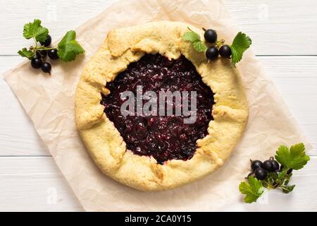 Tarte ouverte de pâte à croûte courte avec cassis, délicieuse galette de jostaberry sur fond blanc Banque D'Images