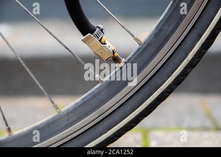 Gonflez un pneu de vélo dégonflé avec une chambre à air en utilisant une valve de voiture, rétablissant efficacement la pression optimale des pneus pour des aventures cyclistes en douceur et en toute sécurité Banque D'Images