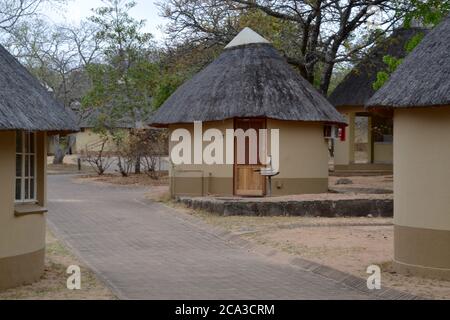 Rangées de petites huttes traditionnelles de toit de chaume à Pretoriouskop Camp de repos dans la réserve de gibier du parc national Kruger dans le Sud Afrique Banque D'Images