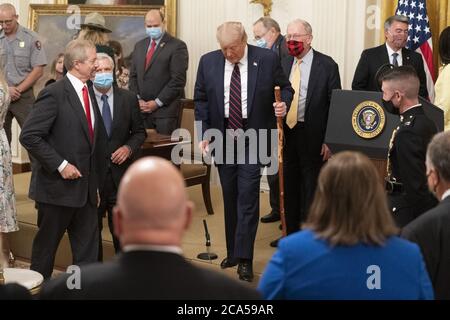 Washington, États-Unis. 04e août 2020. Le président des États-Unis Donald Trump marche avec un bâton de marche qui lui a été remis par le sénateur américain Lamar Alexander R-TN, lors d'une cérémonie de signature pour H.R. 1957 - The Great American Outdoors Act à la Maison Blanche à Washington, DC, le mardi 4 août 2020. Photo de Chris Kleponis/UPI crédit: UPI/Alay Live News Banque D'Images