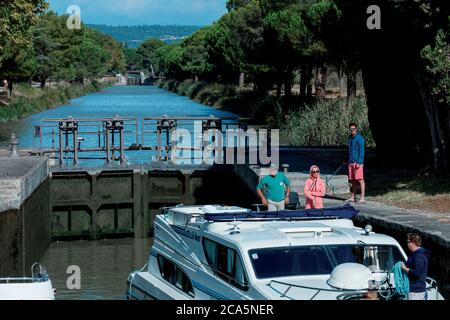 France, Aude, Canal du midi, classée au patrimoine mondial de l'UNESCO, Salleles d'Aude, personnes assistant aux manœuvres de barges dans une écluse Banque D'Images