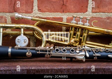 Instruments de musique dont trompette trombone et clarinette sur mur de briques devant le Jazz club Banque D'Images