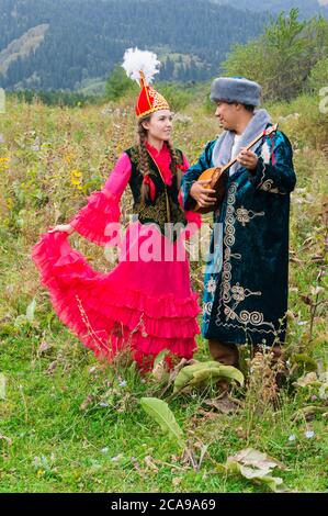 Homme Kazakh dombra chanter et jouer pour une femme, le Kazakh village ethnographique Aul Gunny, Talgar ville, Almaty, Kazakhstan, en Asie centrale, pour editori Banque D'Images