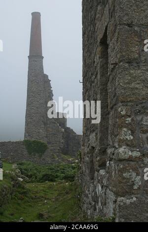 Ruines de Carn Galver, Cornwall Mine de Tin en brume. Vestiges de bâtiments miniers et de travaux entourés de brume format Portrait Banque D'Images