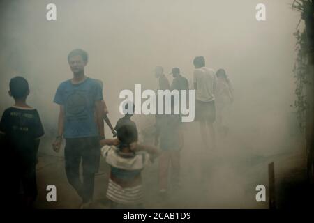 Des agents du bureau de santé local qui mènent une séance de formation de buée sur les insecticides, une prévention de l'éclosion de la dengue dans une région dense et peuplée de Jakarta. Banque D'Images