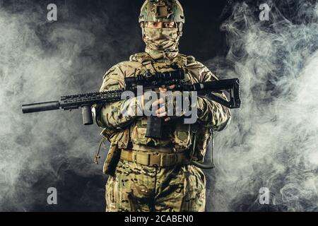 attaque pendant la guerre. homme effectuant un service militaire visant son fusil d'arme côté, allant à l'attaque Banque D'Images