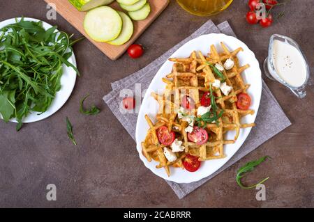 Gaufres courgettes au fromage de chèvre, tomates, arugula. Une alimentation adéquate. Nourriture saine. Vue de dessus Banque D'Images