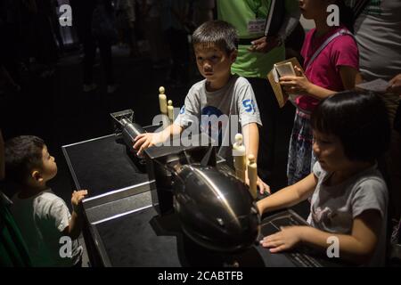 Hiroshima, Japon. 13 août 2019. Enfants regardant des modèles miniatures de la bombe d'atomib nommée « petit garçon » (L) qui a été lâché sur Hiroshima le 6 août 1945 et « Fat Man » (R) qui a été lâché sur Nagasaki le 9 août 1945, Au Musée commémoratif de la paix d'Hiroshima. Le Musée commémoratif de la paix d'Hiroshima est situé dans le Parc commémoratif de la paix d'Hiroshima et a été créé en 1955, 10 ans après le bombardement atomique d'Hiroshima et de Nagasaki. Crédit : Guillaume Payen/SOPA Images/ZUMA Wire/Alay Live News Banque D'Images