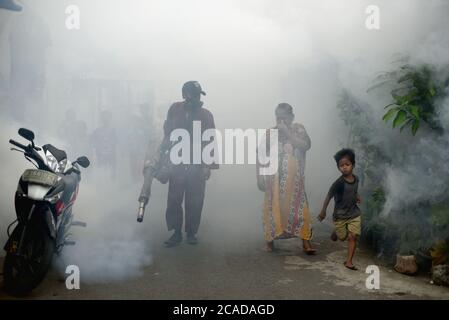 Des agents du bureau de santé local qui mènent une séance de formation de buée sur les insecticides, une prévention de l'éclosion de la dengue dans une région dense et peuplée de Jakarta. Banque D'Images