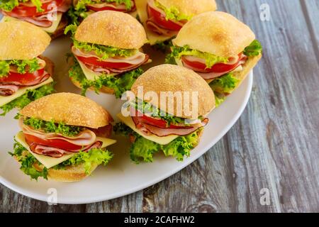 Délicieux sandwiches préparés à partir d'un rouleau de ciabatta avec du jambon, du fromage, de la laitue et de la tomate. Banque D'Images