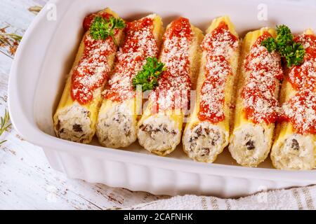 Pâtes cannelloni farcies au fromage ricotta, à la viande et aux tomates. Banque D'Images