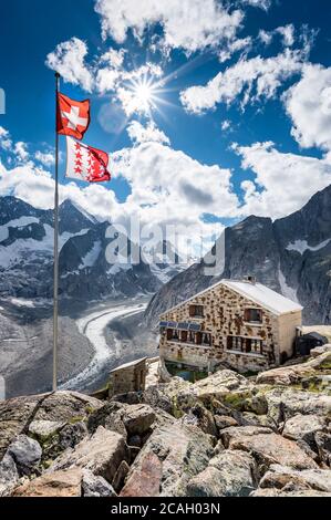 Cabane de montagne oberaletsch avec glacier Oberaletsch et drapeau suisse et valaisan Banque D'Images