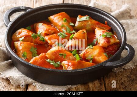 rouleaux de chou farcis avec du bœuf haché et du riz et cuits avec une sauce tomate chaude en gros plan dans un bol sur la table. Horizontale Banque D'Images