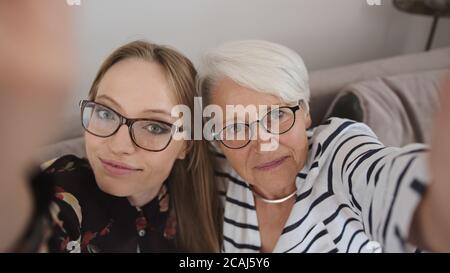 Mère et fille prenant un selfie ar ayant un appel vidéo. De vraies personnes. Photo de haute qualité Banque D'Images