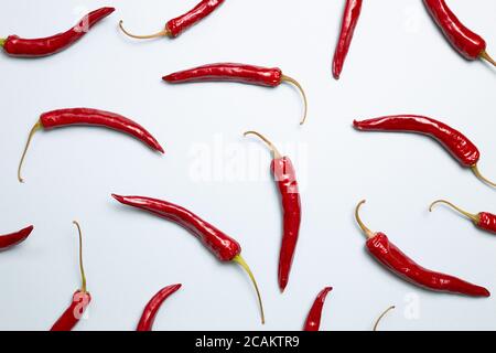 Piments rouges chauds sur fond bleu. plat, vue du dessus Banque D'Images
