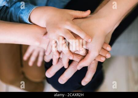 Parents et enfants tenant les mains ensemble à l'intérieur, gros plan Banque D'Images