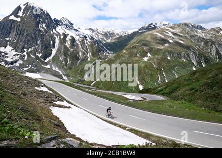 Cycliste sur le col de Nufenen dans les Alpes suisses, qui relie les cantons du Valais et du Tessin, Suisse Banque D'Images