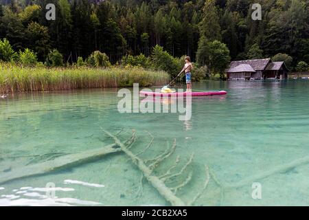 Young boy sur paddleboard sur le lac Banque D'Images