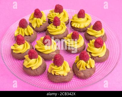 biscuits bruns à la crème jaune et aux framboises Banque D'Images