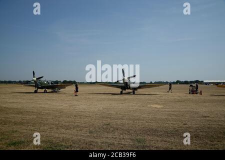 Un avion Spitfire a atterri sur l'aérodrome de Headcorn à Kent, dans le sud-est de l'Angleterre, au Royaume-Uni, et l'équipage au sol s'approche. Banque D'Images