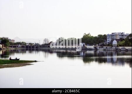 Un bateau contre ciel clair et des collines situé dans le lac Fateh sagar dans la ville d'Udaipur de l'état Rajasthan, Inde Banque D'Images