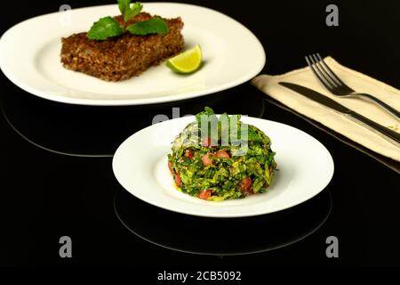 délicieux kibe cuit sur un plat de bronco photographié dans un arrière-plan noir Banque D'Images