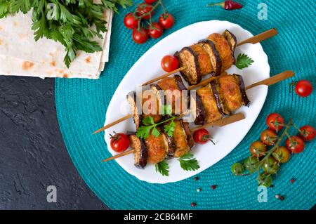 Boulettes de viande graissées d'aubergines sur brochettes. Kebab de poulet avec légumes. Assiette à viande. Vue de dessus Banque D'Images