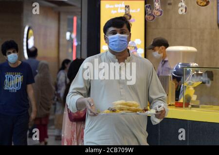 (200811) -- ISLAMABAD, le 11 août 2020 (Xinhua) -- UN homme transporte sa nourriture à un tribunal de restauration dans un centre commercial d'Islamabad, capitale du Pakistan, le 10 août 2020. Le gouvernement pakistanais a annoncé qu'il allait assouplir la plupart des restrictions COVID-19 restantes du pays à partir de lundi, y compris l'ouverture de théâtres, de cinémas et de restaurants, selon les médias locaux. (Xinhua/Ahmad Kamal) Banque D'Images