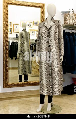 Python blanc fait main manteau élégant de mode sur un mannequin dans un magasin de luxe de grande rue. Shopping à Rome, Italie, Europe Banque D'Images