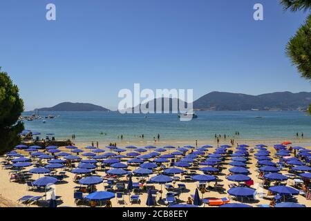 Vue imprenable sur une plage de sable sur les rives du golfe des Poètes avec le promontoire de Porto Venere et l'île de Palmaria (site de l'UNESCO), Italie Banque D'Images