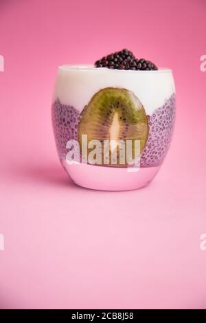 Gros plan vertical de délicieux pudding de chia noir avec blackberry et kiwi Banque D'Images