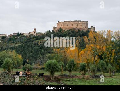 Ancien château médiéval et ville de Pedraza à Segovia, Espagne. Ciel spectaculaire avec nuages orageux au coucher du soleil. Forêt d'automne et paysage bucolique Banque D'Images