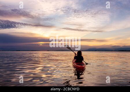 Kayak pendant un coucher de soleil coloré Banque D'Images