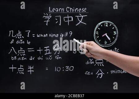 Apprendre le chinois à raconter l'heure dans la salle de classe. Banque D'Images