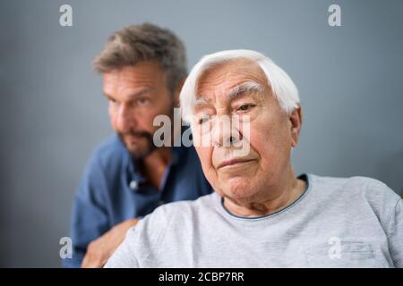 Vieil homme âgé avec Alzheimer obtenir du soutien et des soins de son Banque D'Images