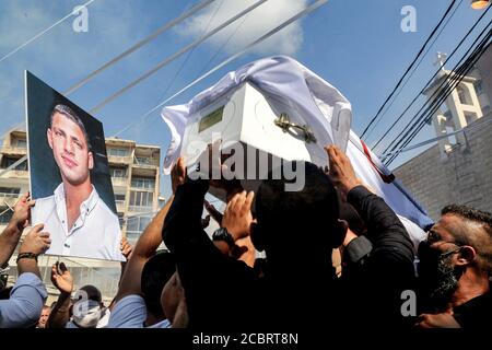 Beyrouth, Liban. 15 août 2020. Les membres de la famille et les amis du feu Ralph Mlahi, qui a été tué lors de l'explosion massive du port de Beyrouth, portent son cercueil pendant les funérailles. Dans l'après-midi du 04 août 2020, deux explosions se sont produites dans le port de la ville de Beyrouth, tuant au moins 171 personnes, en blessant au moins 6000 et en ayant déplacé quelque 250,000 à 300,000. Credit: Marwan Naamani/dpa/Alamy Live News Banque D'Images