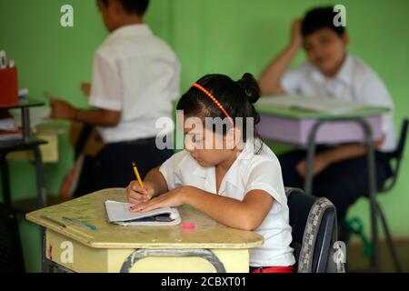 Une écolière de Maleku étudie dans son école de village dans la réserve indienne de Maleku, Tongybe, province d'Alajuela, Costa Rica. Banque D'Images