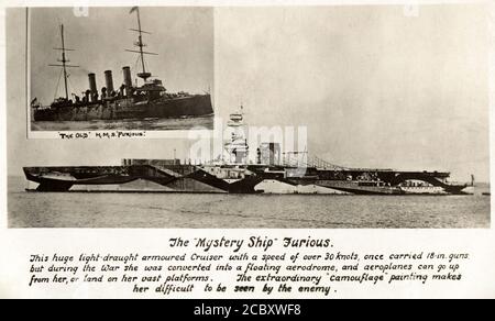 Carte postale de photographie intitulée “le “vaisseau de mystère” furieux” représentant le premier porte-avions de la Royal Navy, H.M.S. Furieux de camouflage éblouissant. Illustration du navire peu de temps après avoir été équipé d'une plate-forme d'atterrissage arrière. vers. 1918 Banque D'Images