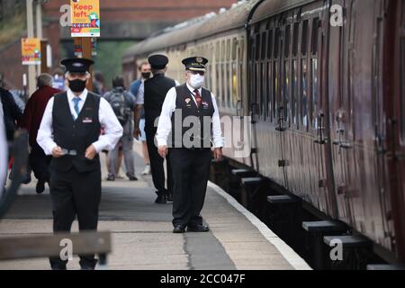 Wansford, Royaume-Uni. 15 août 2020. Le Maître de la station sur la plate-forme comme le chemin de fer de la vallée de Nene ont repris le train à vapeur de Wansford à Peterborough après la pandémie du coronavirus COVID-19 les a forcés à s'arrêter pendant le confinement. Le train à vapeur de la bataille d'Angleterre de 92 escadrons 34081 a été préparé et est prêt à partir, les wagons ayant leur capacité réduite pour permettre de nouvelles lignes directrices de distance sociale. Crédit : Paul Marriott/Alay Live News Banque D'Images