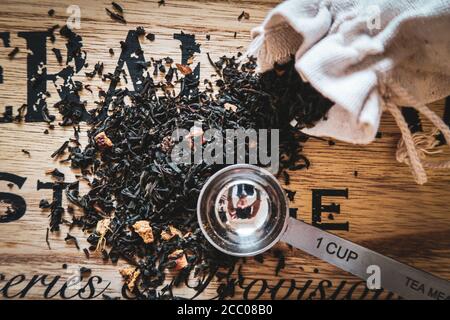 Vue de dessus de Da Hong Pao thé oolong sombre feuilles sur une table en bois avec une petite cuillère Banque D'Images