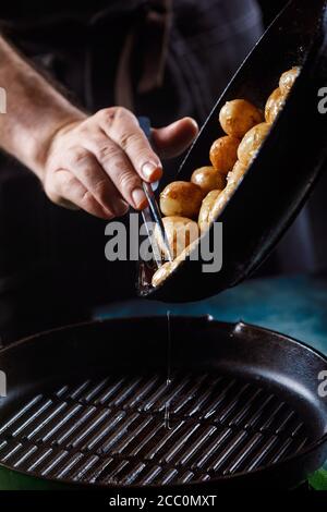 Jeunes pommes de terre bouillies à l'huile et à l'ail rôti, dans un plat en bois. Banque D'Images