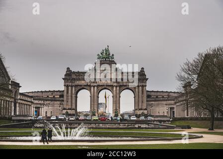 Les gens font une photo avec les populaires Arcades du Cinquantenaire lors d'une sombre journée d'hiver. Journée sinistre au Parc du cinquantième anniversaire - Bruxelles Banque D'Images