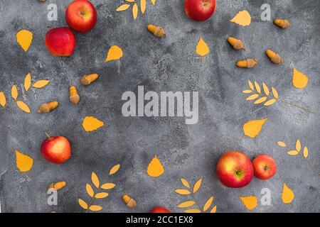 Composition d'automne avec feuilles d'automne, pomme et glands sur fond sombre. Concept de jour de Thanksgiving. Flat lay, vue de dessus Banque D'Images