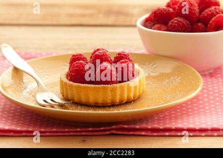 Tartelette framboise sur plaque avec bol de framboises sur table, Close up Banque D'Images